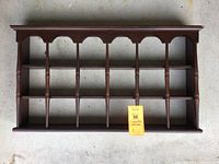 Full top view of the wooden wall rack showing the three-shelf design and vertical spindle dividers.