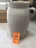 Full view of the 5-gallon stoneware butter churn showing its three handles and cylindrical shape.