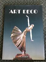 Front cover of the Art Deco book with an Art Deco style statue of a dancing woman and the author's name Eva Weber.