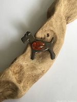 Front view of the silver Scotty dog brooch showing the amber stone inset and dog details.