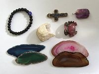 Top-down view of all items laid out, showing bracelet, geodes, pendants and figurine.