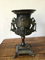 Front view of the full urn showing overall shape, relief details, handles and base