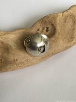 Close-up front view of the silver dome ring showing the rounded bulbous top and tarnishing.