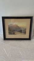 Framed lithograph of a Scottish river landscape with mountains and trees, in a dark wood frame, on a white background.