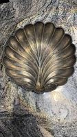 Top view of vintage silver plated scallop shell bowl dish showing petal-like ridges and beaded edge.