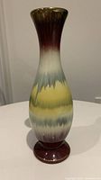 Front view of the vintage West Germany pottery vase showcasing its multicolor drip glaze and flared neck.