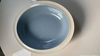 Oval Wedgwood serving dish casserole with light blue glazed interior and white rim, top view showed overall condition and color.