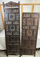 Two ornate wood divider panels side by side showing full height and carved pattern details