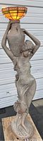 Full view of statue floor lamp showing woman holding urn and stained glass shade
