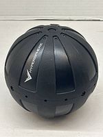 Black Hypersphere vibration massage ball with textured panels and central button for vibration control.