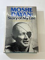 Front cover of book showing title, subtitle, and large photo of Moshe Dayan.