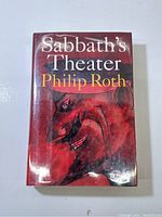 Front cover of the book showing the title, author, and abstract illustration in red tones.