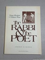 Front cover of the book 'The Rabbi & The Poet' by Victor Reichert and Robert Frost showing title and authors' names with a photo of the two men playing croquet.