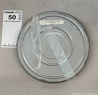 Top view of the metal film can with tape label 'CABARET' visible.