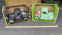 Both vintage trucks in original packaging with visible front and sides