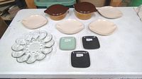 Photo showing entire set on table: 4 Roseville Raynor bread plates, 2 lidded Pyrex bowls, 3 Glidden small square plates, 1 deviled egg plate and clear glass deviled egg tray.