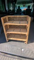 Front view of vintage wicker shelf showing 3 levels and woven lattice back