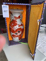 Photo of vase inside original decorative box lined with yellow silk.