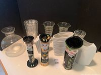 Full lot showing all vases including porcelain art deco, painted women vases, and clear glass pieces