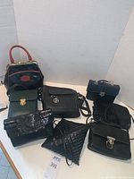 View of all seven purses arranged together showing variety of styles and sizes