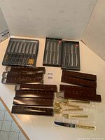 Overview of all flatware boxes, loose utensils, and three packages of steak knives