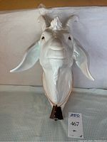 Front view of the white glazed ceramic bearded goat bust showing detailed facial features and bell collar.