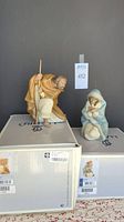 Both figurines displayed on original Lladro boxes against neutral background.