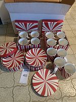 Full set including 12 small dessert plates and 12 mugs in original peppermint design boxes.