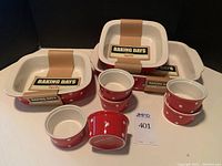 Photo showing all items including three red with white polka dot casserole dishes and six matching ramekins, tagged with Baking Days by Spode.
