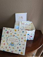 Photo of a decorative floral box labeled 'Cards for All Occasions' containing over 50 new greeting cards for various occasions.