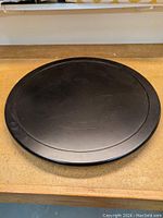 Top view of a black circular Lazy Susan showing smooth surface and diameter size.