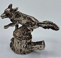 Side view of the vintage silver fox figurine standing on a tree stump, showing detailed fur texture and 800 marking.