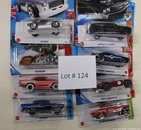 Eight Hot Wheels vehicles in original packaging displayed with lot number.