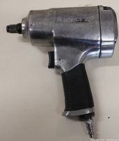 Left-side view of the Mastercraft air impact tool showing the air inlet, trigger, and the front where the socket would attach.