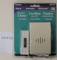 Front view of the original retail packaging showing the wireless chime unit and door button in sealed plastic blister with teal and white backing card.