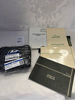 Jaguar manuals and a sealed OEM part with packaging showing part number JDE773 AU0001 V7
