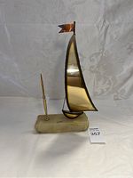 Full view of copper metal sailboat sculpture with marble base and pen holder