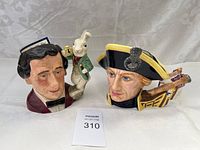 Shows both Royal Doulton large character mugs side by side, Lewis Carroll with White Rabbit and the historical figure with ship handle.