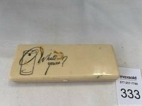 Exterior of closed plastic case with drink illustration and text "What's Yours?".