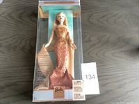 Full view of November Topaz Barbie doll in original display box showing front and packaging.
