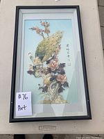 Full view of the framed artwork showing peacock and floral scene with Asian script on the right side.