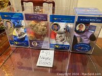 Front view of four NSYNC bears in clear display boxes showing each member and the special edition bear