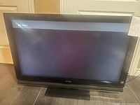 Front view of Sony TV powered on with HDMI 1 input shown on screen.