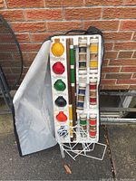 Full croquet set with case open showing mallets, balls, and wickets.