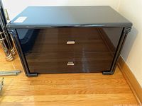 Front elevational view of nightstand showing two drawers and hardware.