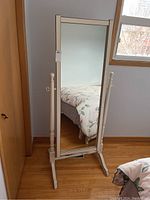 Front view of tall rectangular standing mirror with wood frame and pedestal base, showing size and paint condition.