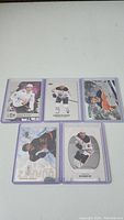 Six Connor McDavid hockey cards shown on a white background inside protective sleeves.