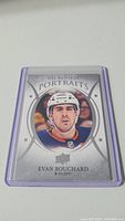 Photo of an Upper Deck Rookie Portraits hockey card featuring Evan Bouchard in an Edmonton Oilers helmet and jersey, set in a protective purple card sleeve.