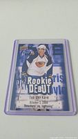 Front photo of Evander Kane Rookie Debut hockey card from 2009 in protective sleeve showing player image and rookie debut text.