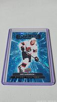 Jake Sanderson rookie card with holographic background in Ottawa Senators uniform inside protective sleeve.